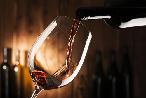 a glass of red wine being poured into it at Hotel Tirolerhof in Leutasch