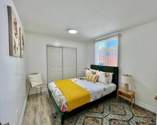 a bedroom with a bed with a yellow blanket at Central San Diego 2 BED Condo in San Diego