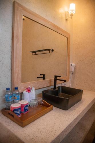 a bathroom counter with a sink and a mirror at Molah Gili Villa in Gili Islands
