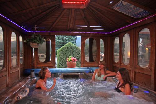 three women in a hot tub in a gazebo at Gateway Inn and Suites in Salida