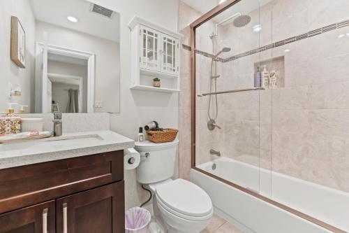 a bathroom with a toilet and a shower and a sink at Peaceful Home Near Beach & Disneyland in Huntington Beach