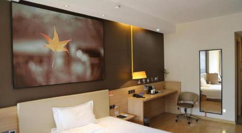 a hotel room with a bed and a desk and a bedroom at IU Hotel Chengdu High-Tech Zone Longhu Times Street in Chengdu