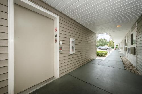 a white door to a building with a driveway at Tampa Bay Extended Stay Hotel in Largo