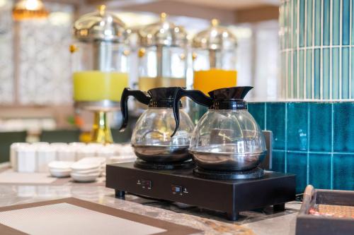 two glass vases sitting on top of a counter at Howard Johnson by Wyndham Phuket Naiyang in Thalang