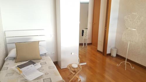 a room with a bed and a mannequin on the wall at Donizetti Royal in Bergamo