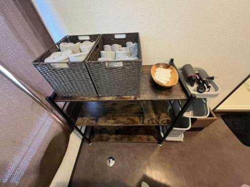 a room with a table with a bowl on it at ステイインアット今福 in Sasebo