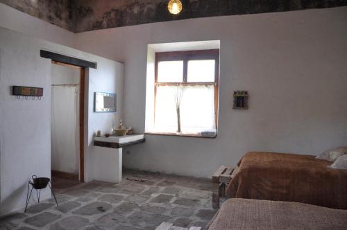 a bedroom with a bed and a window at Hacienda Santa Barbara Casa Malinche in Huamantla