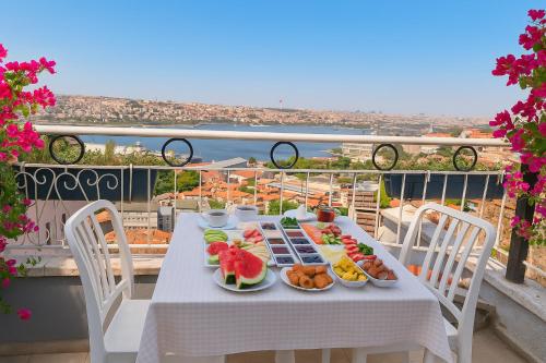 a table with plates of food on a balcony at The Big Urban Stay in Istanbul