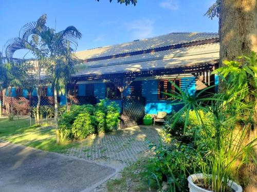 a house with a lot of plants in front of it at Pilton Resort in Prachuap Khiri Khan