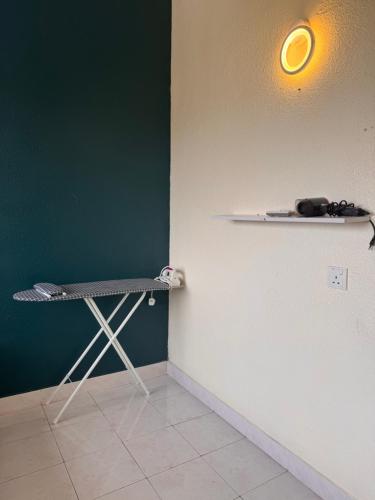a room with a shelf on a green wall at Sri Sayang sunset 2 bedroom in Batu Ferringhi