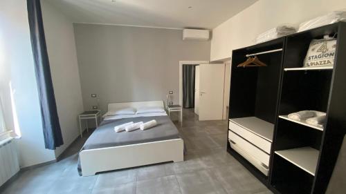 a bedroom with a bed with two towels on it at Residenza Ermete in Civitavecchia