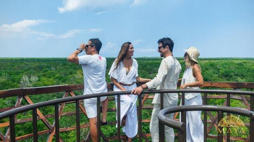 a group of people standing on top of a fence at Peregrina Tulum 104A 2-Bedroom Condo in Tulum