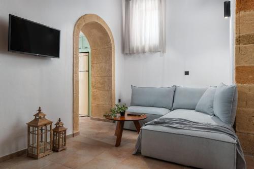 a living room with a couch and a tv at Casa della Nonna Rhodes in Gennadi