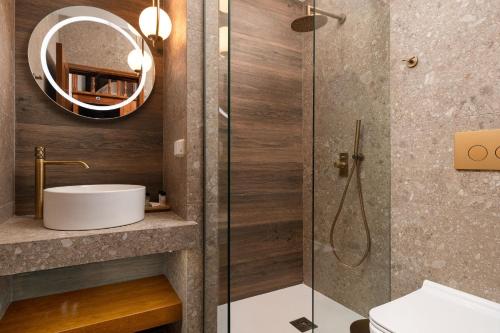 a bathroom with a shower with a sink and a mirror at Casa della Nonna Rhodes in Gennadi