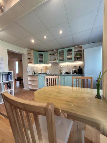 a kitchen with a large wooden table in a room at 3-room homey apartment in Kärdla in Kärdla