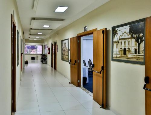 an empty corridor of a hospital with doors and a hallwayngth at Monte Serrat Hotel in Santos