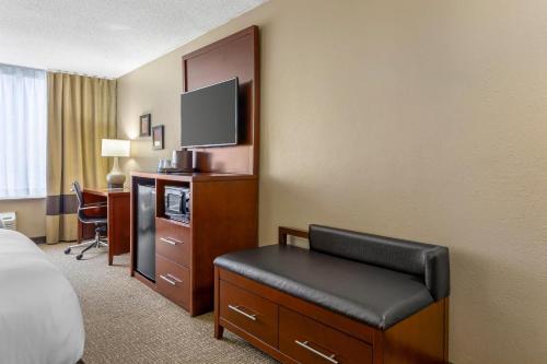 a hotel room with a bed and a chair and a television at Comfort Inn Memphis Downtown in Memphis
