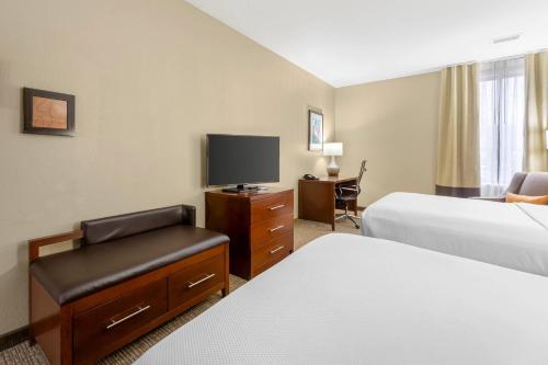 a hotel room with two beds and a flat screen tv at Comfort Inn Memphis Downtown in Memphis