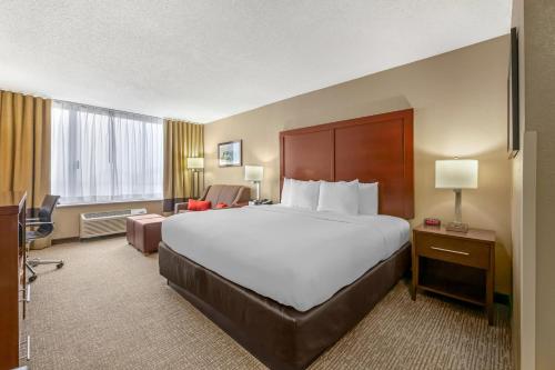 a hotel room with a large bed and a desk at Comfort Inn Memphis Downtown in Memphis