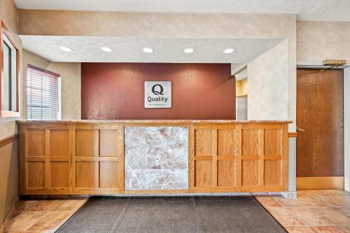 a lobby with a waiting room with wooden cabinets at Quality Inn & Suites Big Stone Gap in Big Stone Gap