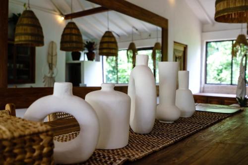 a group of white vases sitting on a table at Spacious 3bdrs villa walkable to Bingin Beach in Uluwatu