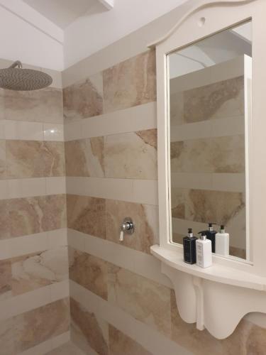 a bathroom with a sink and a mirror at Long Story Guest House in Plettenberg Bay