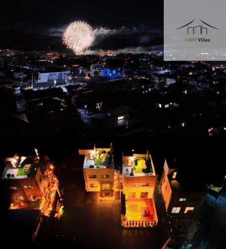 a fireworks display over a city at night at ヴィラ山間堂Panorama Villa BBQ Bonfire Fuji view Annovillas Sankando in Fujikawaguchiko