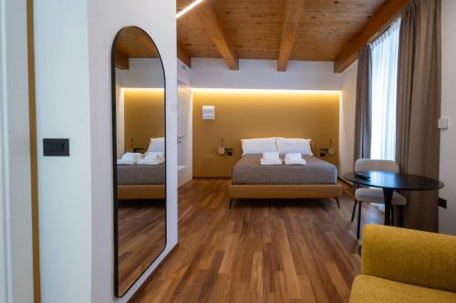 a bedroom with a mirror and a bed and a table at The Crispi House in Vasto