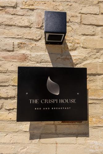 a sign for the christchurch house on a brick wall at The Crispi House in Vasto