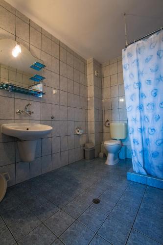a bathroom with a sink and a toilet at Guest House ,, Ekaterina" in Nesebar