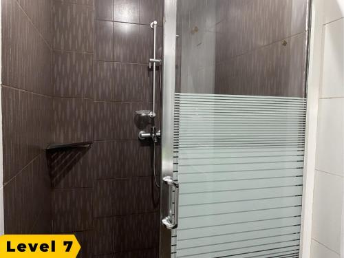 a shower with a glass door in a bathroom at Lalaguna Villas Luxury Dive Resort and Spa in Puerto Galera