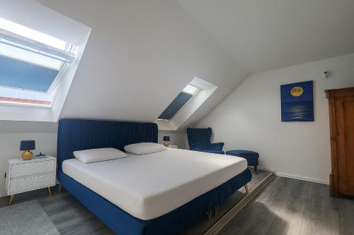 a bedroom with a blue and white bed and a window at Maisonette Fewo's Schlabendorf am See in Luckau