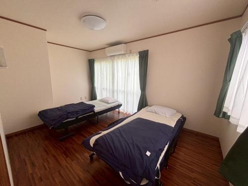 Postel nebo postele na pokoji v ubytování ゆいくる処まーす