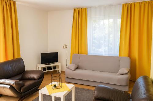 a living room with a couch and a tv at Noclegi Międzylesie - Aktywny Wypoczynek in Międzylesie