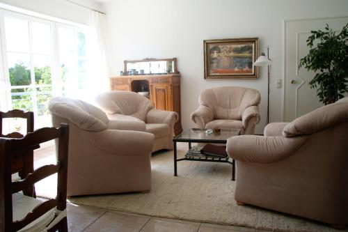 a living room with two chairs and a table at Im-Dorfblick in Pronsfeld