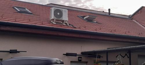 a roof of a building with an air conditioner on it at Borostyán Vendégház Eger in Eger