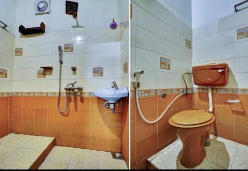 un baño con inodoro y lavabo en Vrindavanam Avocado, en Alleppey