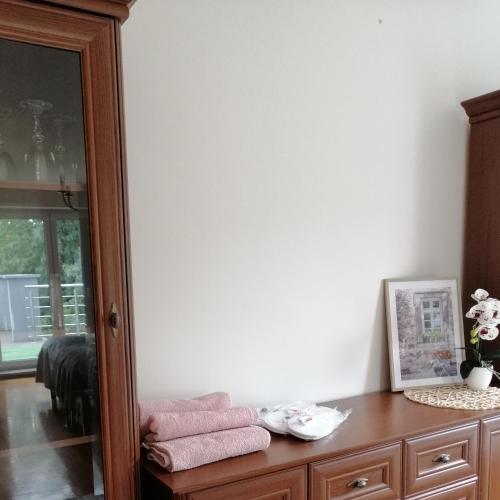 a room with a wooden cabinet and a mirror at Pokoje nad jeziorem Gdańsk in Gdańsk
