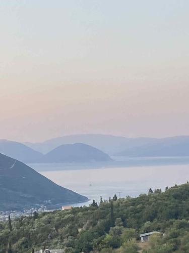 a view of a body of water from a hill at RAVANIS Home in Áyios Pétros