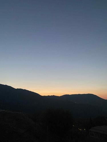 a view of the mountains at sunset with the sky at RAVANIS Home in Áyios Pétros
