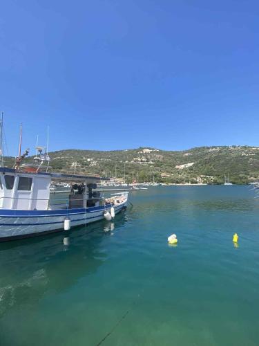 a boat docked at a dock in the water at RAVANIS Home in Áyios Pétros