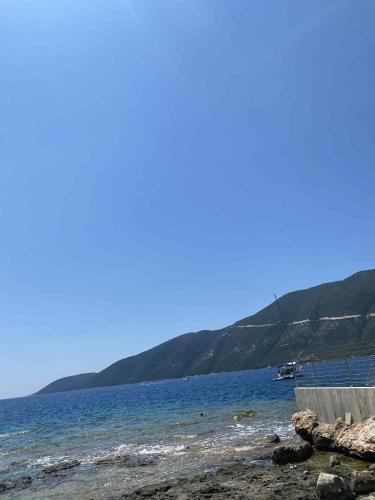 a body of water with mountains in the background at RAVANIS Home in Áyios Pétros