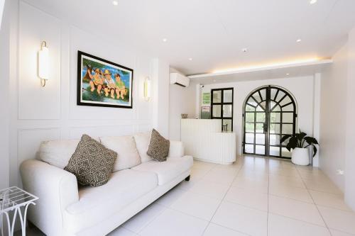 a white living room with a white couch at ACHITEL Tarlac in Tarlac