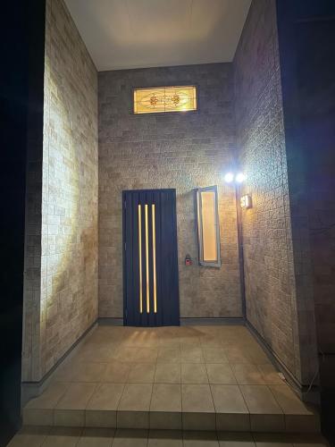 a room with a blue door and a light at リゾートヴィラ宮島 Sunset terrace in Hatsukaichi