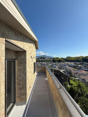 a balcony with a view of a city at リゾートヴィラ宮島 Sunset terrace in Hatsukaichi