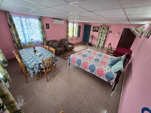 an overhead view of a room with a bed and a table at Hrishi's Terrace Home. in Guwahati