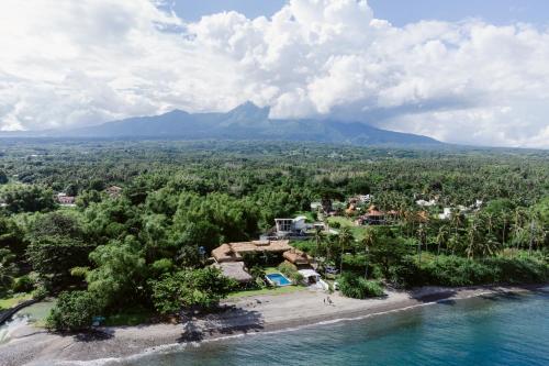 an aerial view of the resort with a mountain in the background at Azure Dive Resort in Dauin