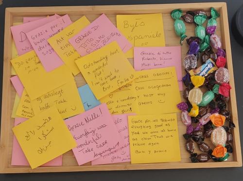 a tray of sticky notes and beads and a box of candy at Casa Amare Aeroporto Fiumicino in Focene
