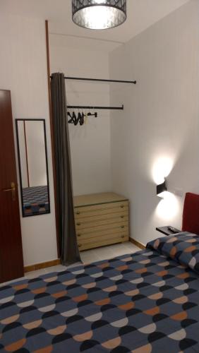 a bedroom with a bed and a dresser and a mirror at Casa vacanze " il muretto" in Gallipoli