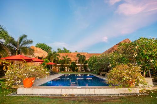 a swimming pool in front of a resort at Azure Dive Resort in Dauin
